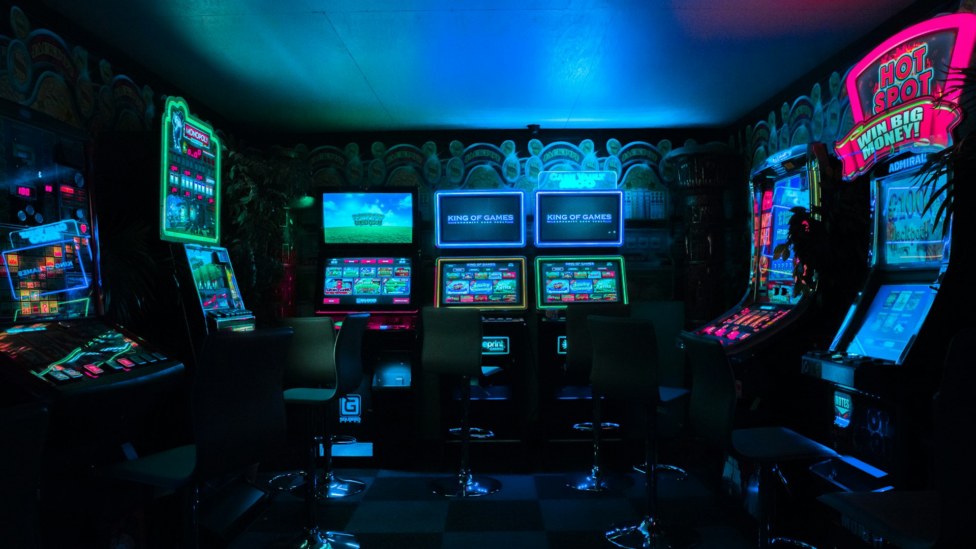 Neon arcade cabinets glowing in a dark gaming lounge